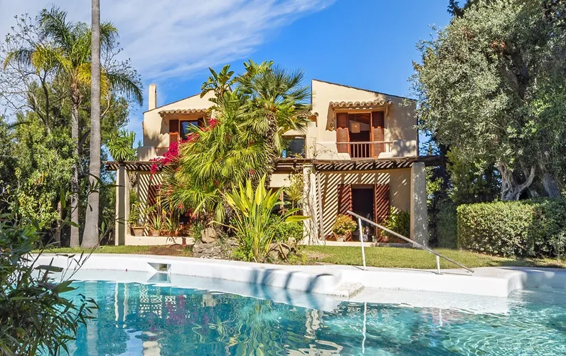 Unique, stylish villa with a large pool, tropical garden, and sea views, in exclusive